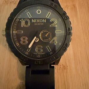 Nixon Black and Gold Accent Dive Watch
